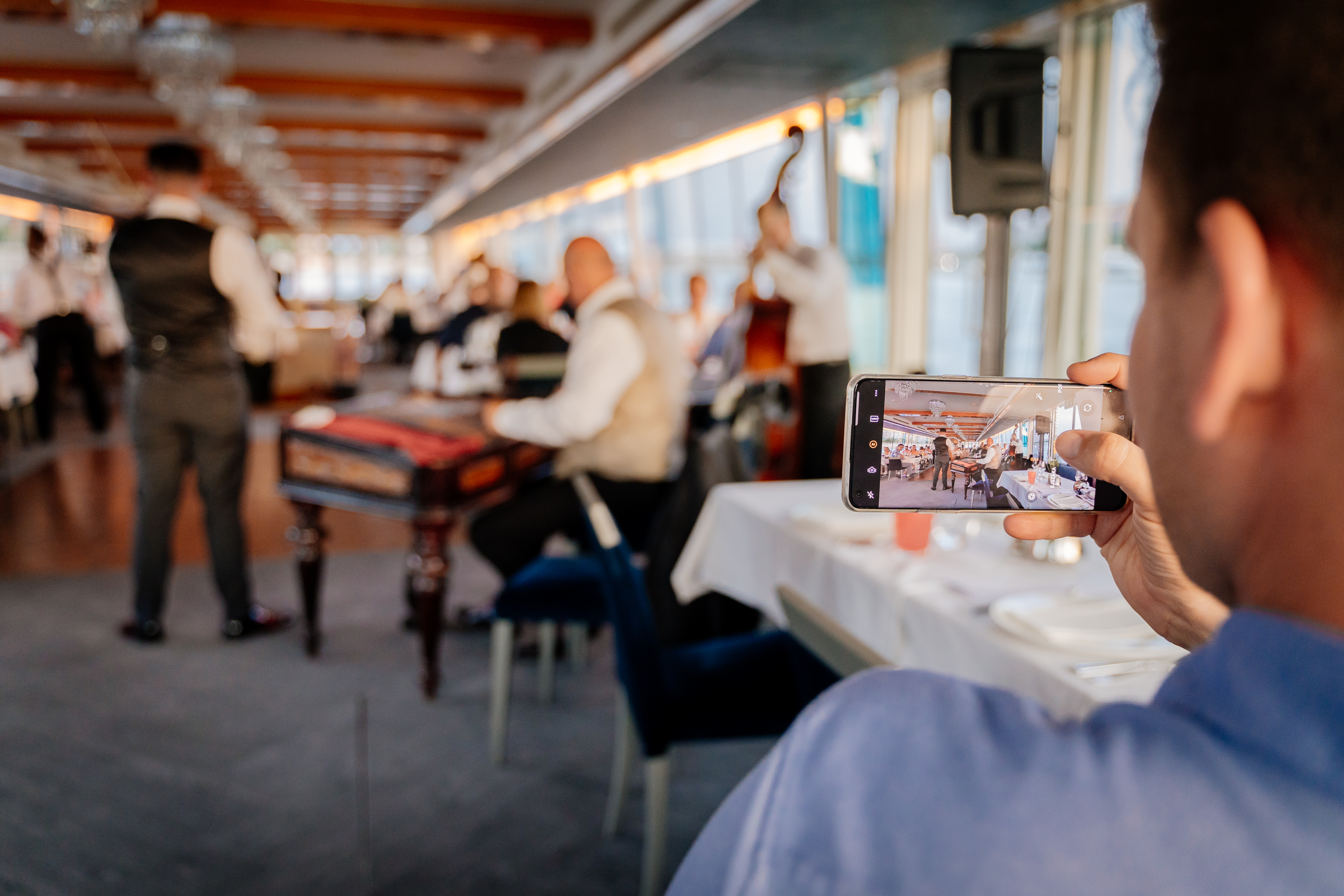 Guest recording live music on a river cruise
