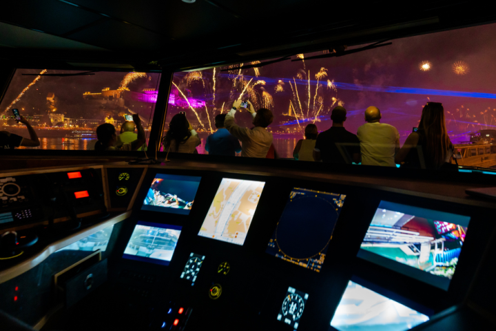 People watching fireworks from a the ship at night.