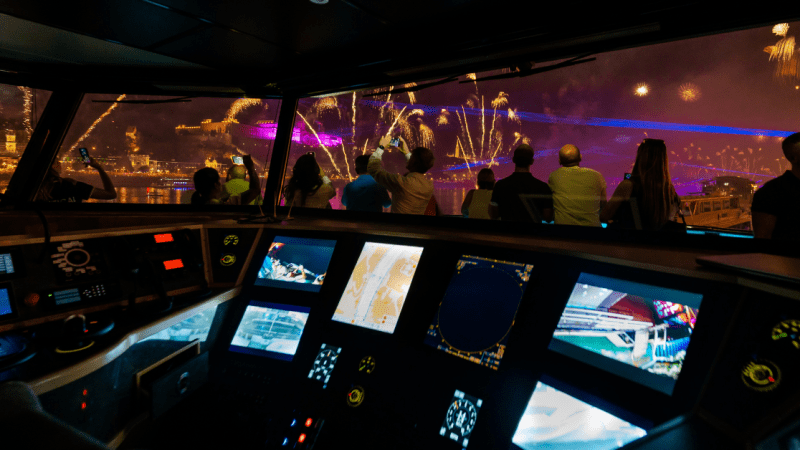 People watching fireworks from a the ship at night.